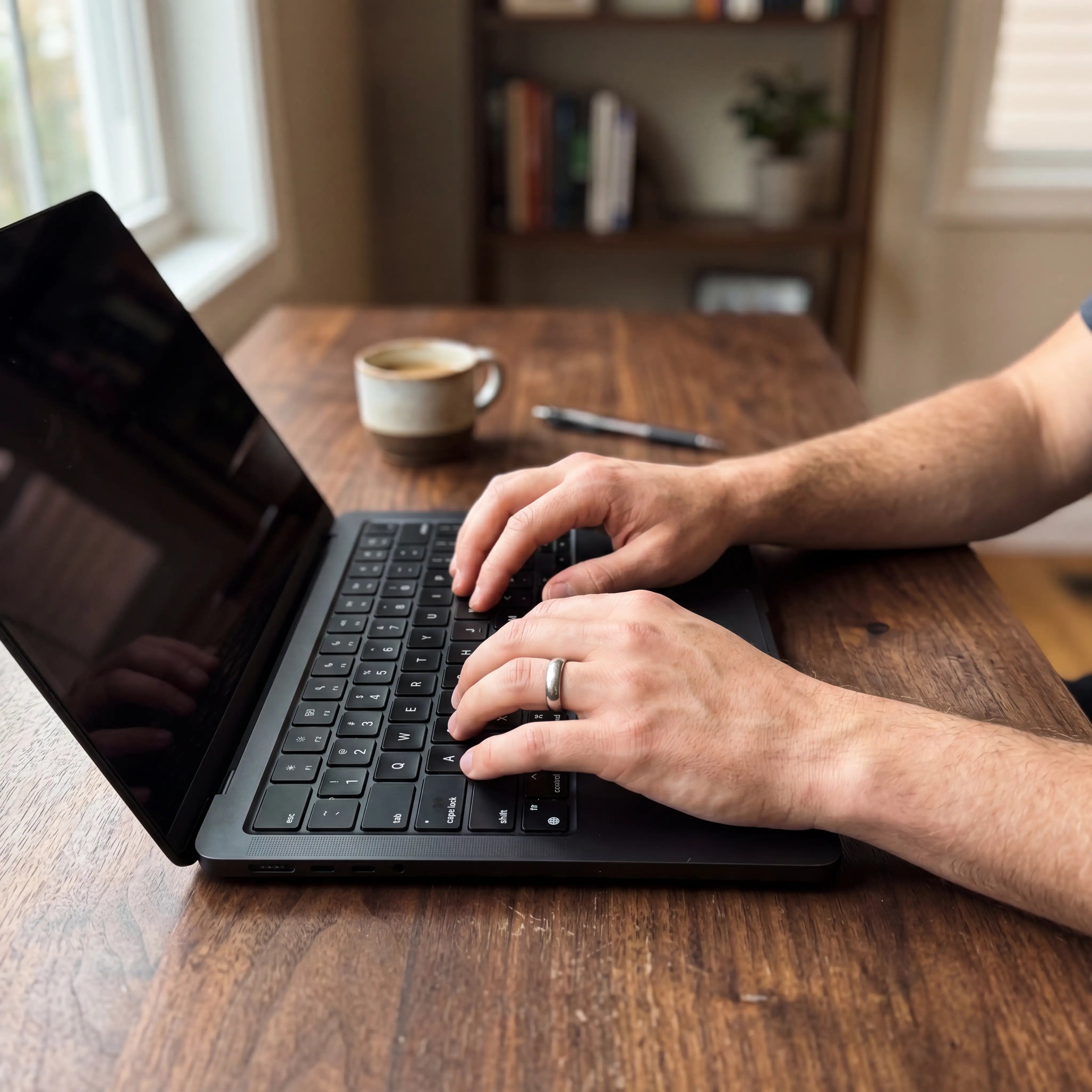 Hands typing in steady, focused flow at a calm desk